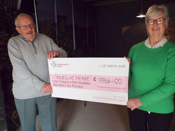 John Cunningham (Vice Chair) and Ella Harvey (Treasurer) display the cheque from the National Lottery.