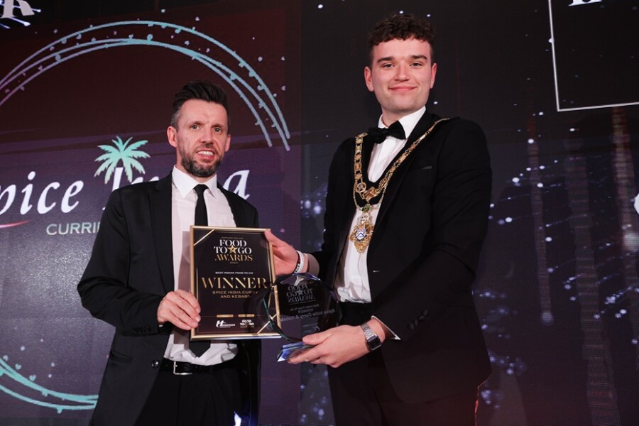Martin Breen, on behalf of Spice India Curry & Kebabs, collects the winner’s trophy for Best Indian Food To Go from the Mayor of Causeway Coast & Glens Borough Council, Cllr Ciaran McQuillan 