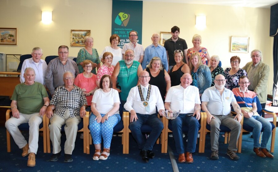Former Chairperson of Newry, Mourne and Down District Council Councillor Michael Savage pictured with members and committee members of New Town Together Men’s and Hen’s Shed.