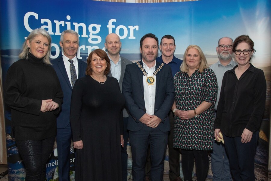 Pictured at the summit were back from left: Lynette Faye (host); Nicholas McCrickard, CDRCN and Chair of Community Planning Partnership; Andrew Patterson, NMDDC Director of Active and Healthy Communities; Simon Sloan, DfC and Gerard Rocks, SHSCT. Front: Lynda Vladeanu, SEHSCT; NMDDC Cllr Pete Byrne, Marie Ward NMDDC CEO, and Colette Rogers, PHA.