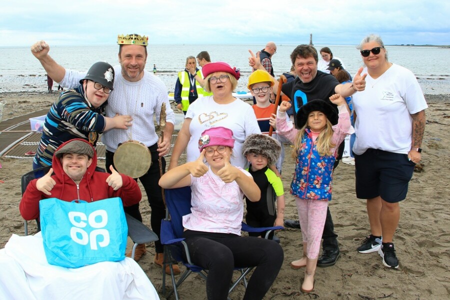 Newry Mourne and Down Council Chairperson, Councillor Pete Byrne with the cast of Little Red Riding Hood a drama created on the beach by Open Arts.