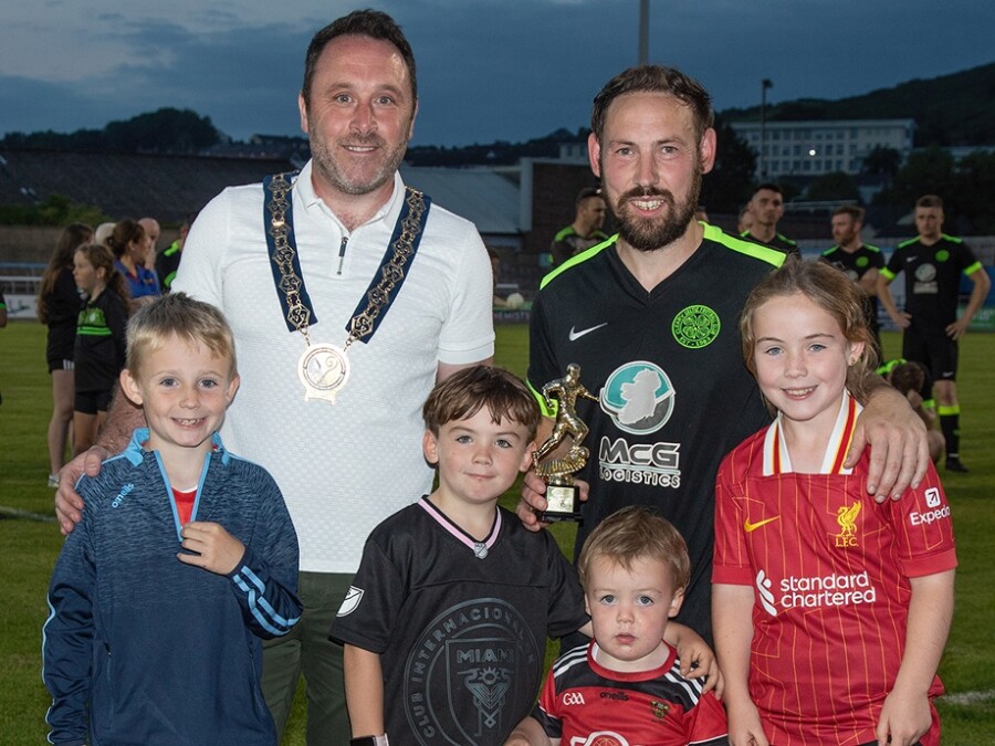 Cllr Pete Byrne, Chairperson of Newry, Mourne and Down District Council congratulates Man of the Match, Cleary Celtic’s Marty Havern with Ruairí Brannigan, Frankie Havern, Luan Havern and Lilah Havern. Photographs: Raphael Mason Photography