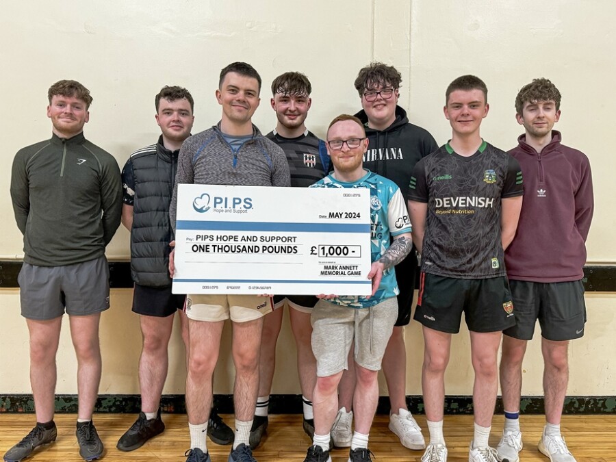 Shea Annett and his friends present a cheque for £1000 to PIPS Hope and Support.