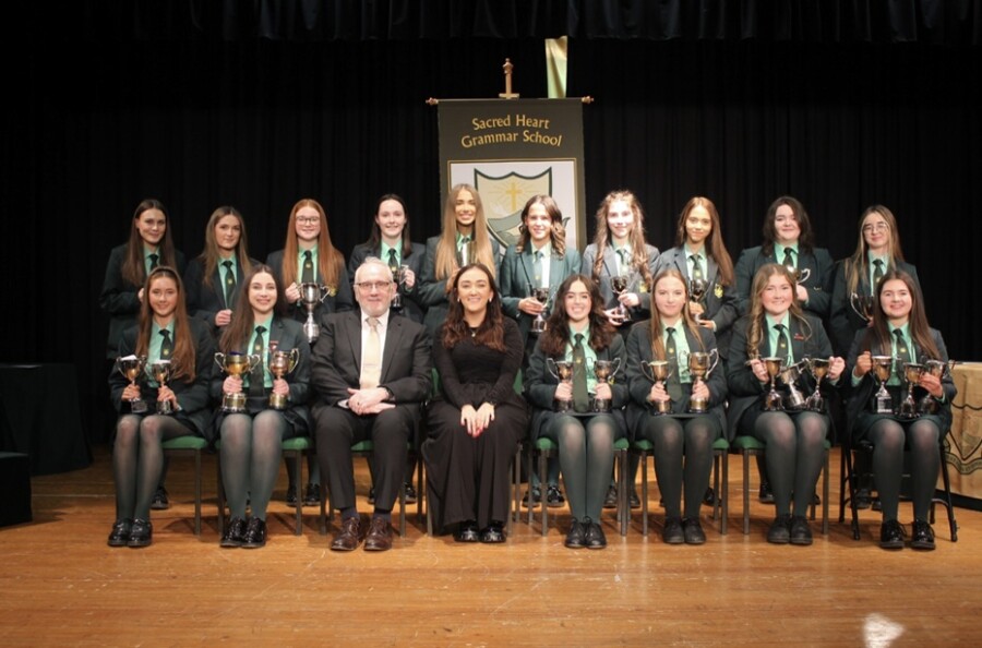 Cup winners who achieved the highest marks in their subject at GCSE, pictured with guest speaker, Ms Anne-Marie Mulholland, and Principal, Mr Shane Comer. 