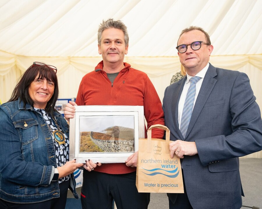 NMDDC Chairperson, Cllr Valerie Harte and NI Water Director of Finance and Regulation, Ronan Larkin with Shaun Jackson who was the overall winner of NI Water’s Centenary calendar.