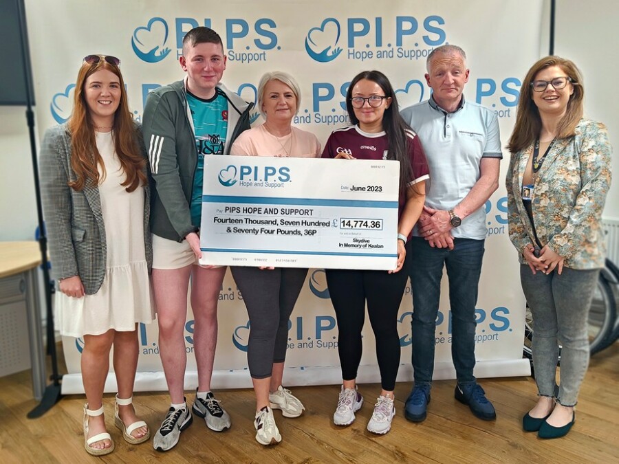 Dad Kevin, mum Sharon and their childrenpictured in the PIPS office on Mill Street presenting the fantastic donation, which will support the services provided by the charity.