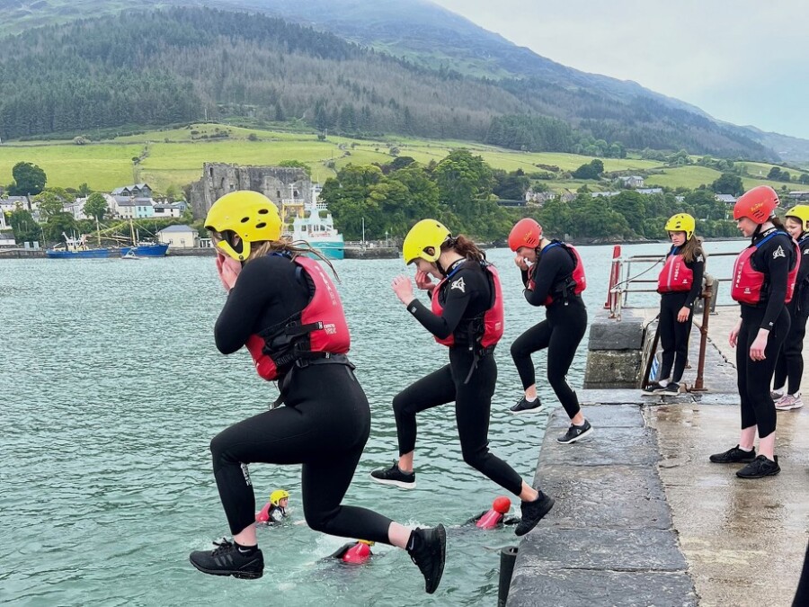 Pupils from St Mary's High School in Newry dive into Carlingford Lough.