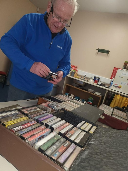 Tommy Fegan, piper and OTMA founder, cataloguing cassettes donated by the family of Joe Gaynor, the blind accordion player who died in Dundalk in 2002.