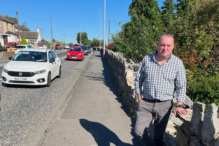 Cllr Aidan Mathers at the damaged wall.