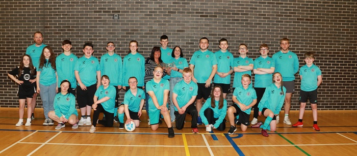 NMDDC Chairperson, Councillor Valerie Harte is photographed with members of the Well Lane Warriors who won the 2023 Derry Foyle Cup in the Sports with Disability competition.