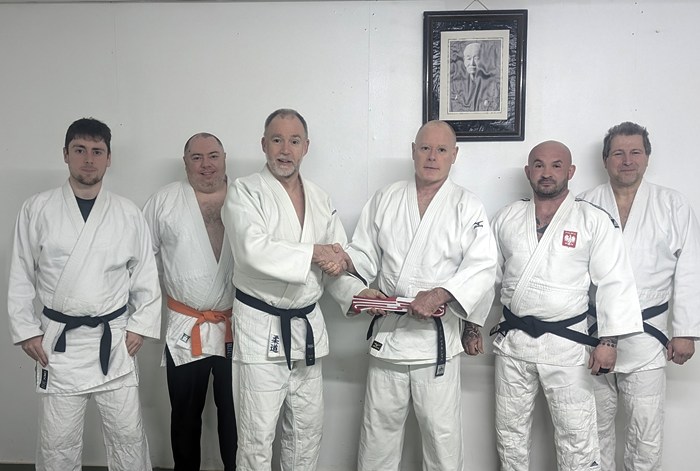 Presenting Paul with his 6th dan Belt. Included from left: Brian Smith, Gerard Moore, Dermot McCaul (Snr Club Coach), Paul McConville, Dawid Jurkiewicz and Olegas Gajosinskas.