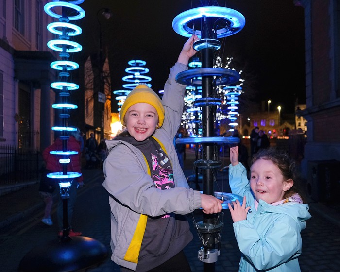 Shorlagh Duffy and Imogen Porter enjoying trying out the Illumaphonium: Halo installation at Sugar Island, Newry.