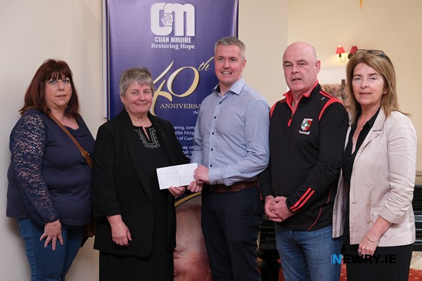 Members of Craobh Rua Hurling Club make a presentation to Sr Sheila Cronin, Head of Home, Cuan Mhuire. Funds were raised at a Spinathon by the club in April. Included from left are Nicola Campbell, Sr Cronin, Niall McGinn, Jim Rowntree and Mary Boyle. Photograph: Columba O'Hare/ Newry.ie 