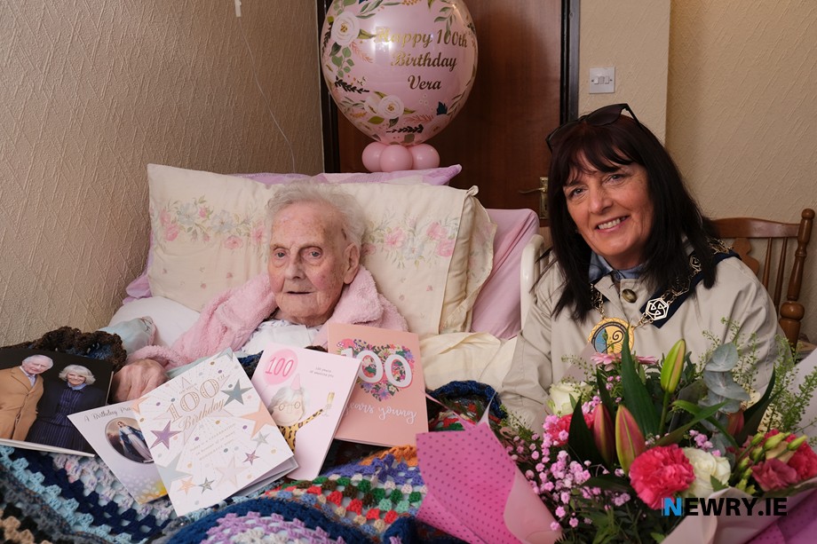 Cllr Valerie Harte, Chairperson, Newry, Mourne and Down District Council presents a bouquet to Vera McGahan on her 100th Birthday. Photograph: Columba O'Hare/ Newry.ie