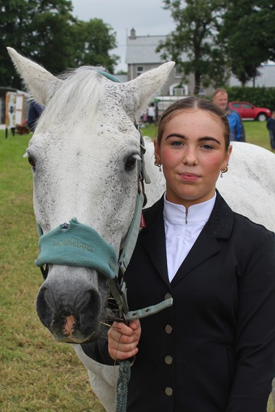 Lucy Connolly, from Newry, taking a break in competition at Newry Show 2024 with her 14-year old Connemara horse: Danny