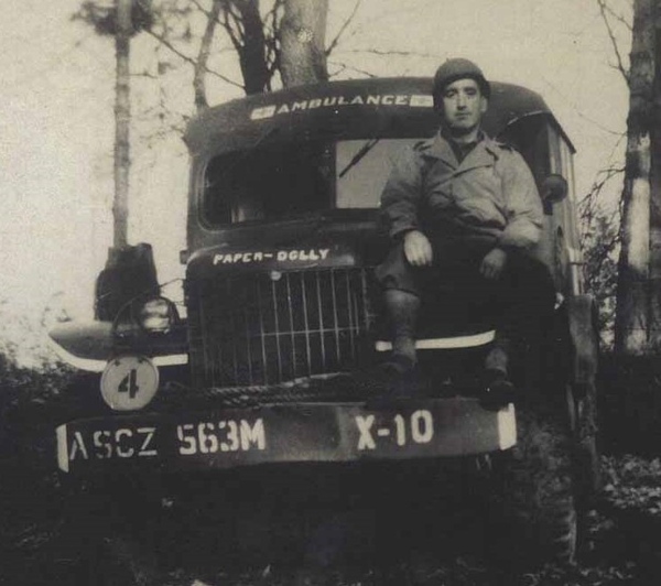 James Quinn sitting on the bonnet of his ambulance. Each ambulance was crewed by a driver and an orderly and could accommodate four litter (stretcher) cases or twelve sitting cases. Newry & Mourne Museum Collection