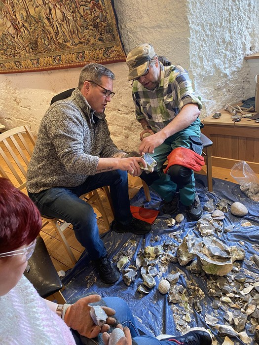 Participants taking part in flint napping at the Arts Crafts and Skills of our Ancestors workshop in Newry and Mourne Museum facilitated by the Community Archaeology programme from Queens University.  