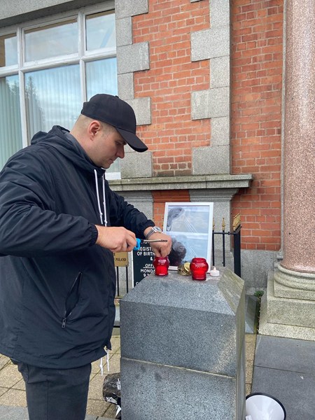 Organiser Dan Gebski lights a candle in memory of Damian Sobol.