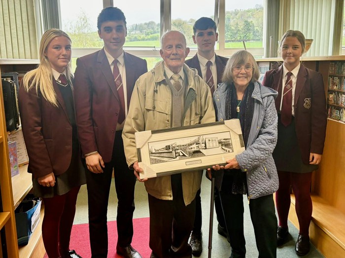 Former principal Michael Warde and art teacher Maureen Smyth makes a presentation of a drawing by Andrew Smyth to current pupils of St Paul's for display in the Michael Warde Library.
