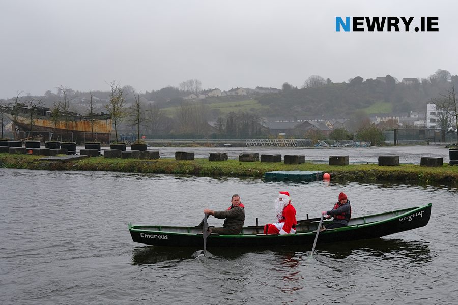  Santa takes a trip in a Currach on the Albert Basin with Dermot Russell and Jeanie Mc Comiskey from Carlingford Lough Currach Club on the oars. Santa was on his way to a children’s party at Drumalane/Quayside Close Community Association with the help of Carlingford Lough Currach Club and Newry Maritime Association. Photograph: Columba O’Hare/ Newry.ie
