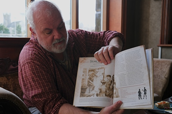 John Farrelly looking over his new book 