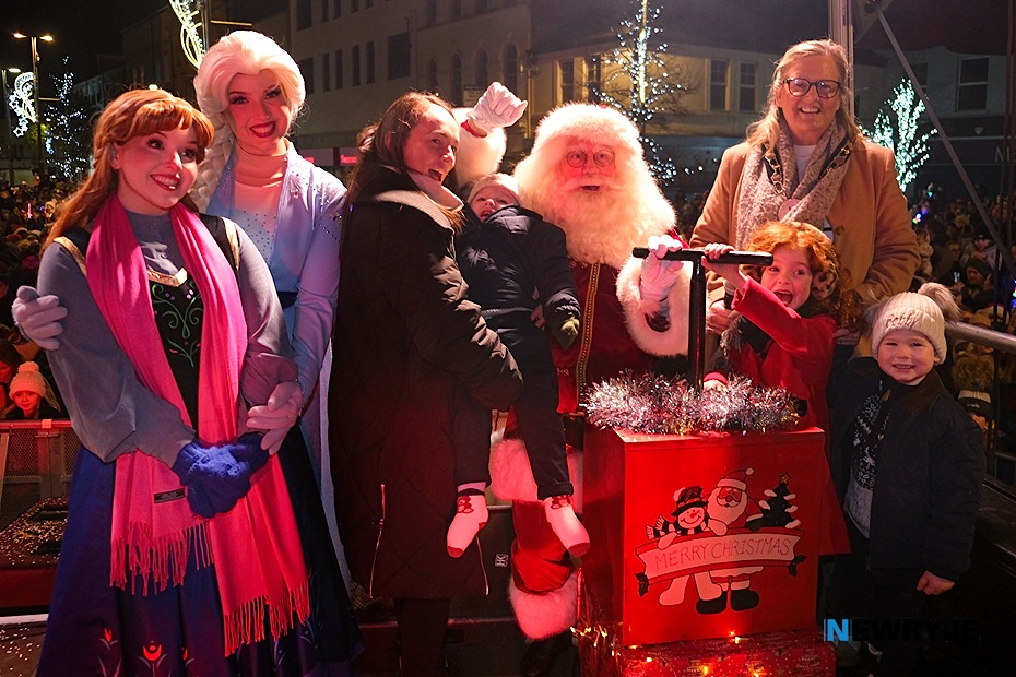 Cllr Geraldine Kearns, Deputy Chairperson, Newry, Mourne and Down District Council and Santa get ready to turn on the Christmas tree lights in Newry with the help of young Harry Collins and family and Elsa and Anna. Photograph: Columba O'Hare/ Newry.ie 