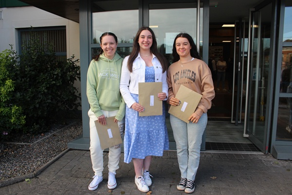 Caoimhe O'Hare, Grace Grimley and Rachel McKee celebrate their results.