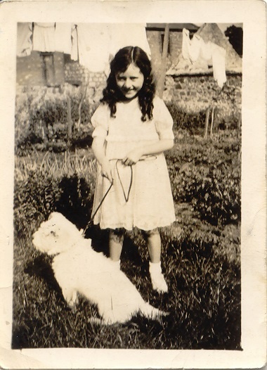 Photograph of Patricia McArdle wearing her confirmation outfit, c.1940. The Limerick lace dress was adapted from her first communion dress, made by her mother. Newry & Mourne Museum Collection