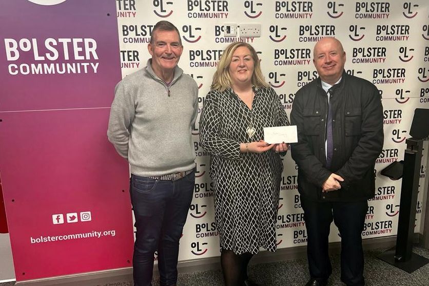 The Housing Executive’s Liam Gunn (Area Manager) presents £250 to Jacinta Linden, CEO of Bolster, and Gerry Flynn, Bolster Board Member.