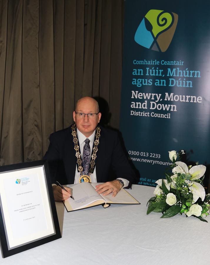Newry, Mourne and Down District Council Chairperson, Councillor Michael Savage signs the Book of Condolence opened in memory of those who lost their lives in the Creeslough tradegy in County Donegal.