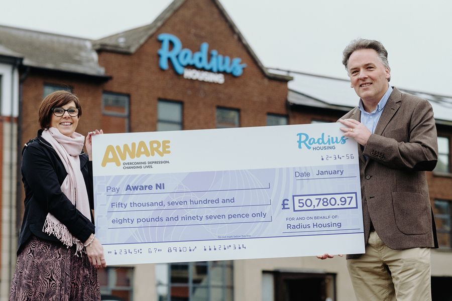 AWARE NI Chief Executive Karen Collins receives a cheque for more than £50,000 from Radius Housing Chief Executive, John McLean.   