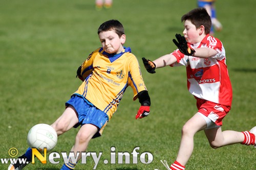 St John Bosco player Pól Óg McCormack and Carrickcruppen player Jarlath Britton in action in the U10 game 