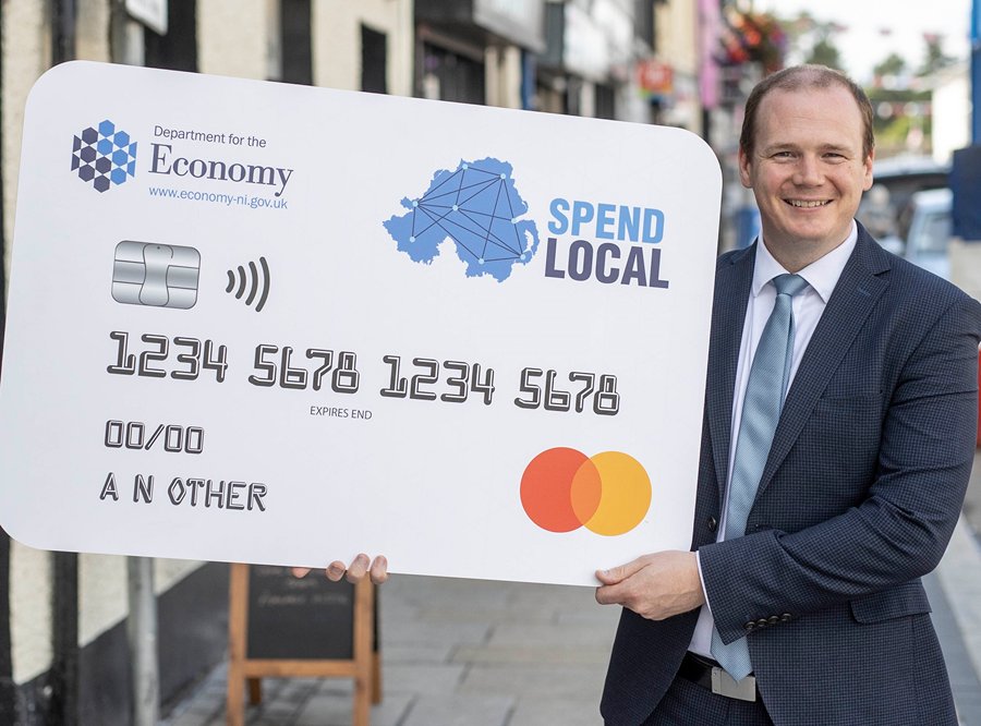 Economy Minister Gordon Lyons with the Spend Local card.