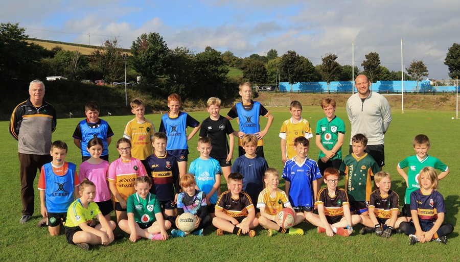 Chairman Redmond O’Hanlon GAC Club Robert O'Neill with Rory Best and the Primary 11 pupils from St. Joseph and St. James and Poyntzpass Primary schools who played a Game of Two Halves, one in Rugby and one in Gaelic Football.