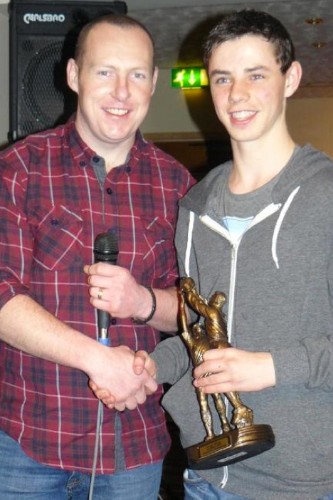 Minor Team Manager Karl Kimmins makes a presentation to the Player of the year Phelim Finnegan 