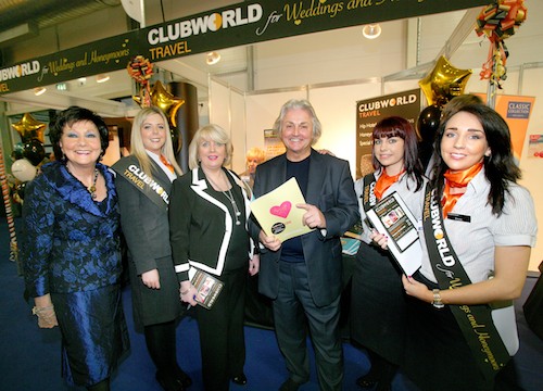 Pictured at the recent Holiday World Show at Belfast’s King’s Hall Pavilions, on the Clubworld Travel’s Honeymoon & Wedding Destinations Pavilion, are (from left) Holiday World organiser Maureen Ledwith; Emma Quinn from Clubworld Travel, Newry; Delia Aston, Clubworld Travel; Royal designer David Emanuel who opened the show; Amy Murphy, Clubworld Travel, Carrick; and Emma Boyd, Clubworld Travel, Banbridge. Pictured at the recent Holiday World Show at Belfast’s King’s Hall Pavilions, on the Clubworld Travel’s Honeymoon & Wedding Destinations Pavilion, are (from left) Holiday World organiser Maureen Ledwith; Emma Quinn from Clubworld Travel, Newry; Delia Aston, Clubworld Travel; Royal designer David Emanuel who opened the show; Amy Murphy, Clubworld Travel, Carrick; and Emma Boyd, Clubworld Travel, Banbridge.