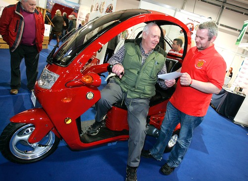 Pictured at the recent Holiday World Show at Belfast’s King’s Hall Pavilions is Robin Jelly on a Eurotrike 160 with Seamus Shannon from Newry. Pictured at the recent Holiday World Show at Belfast’s King’s Hall Pavilions is Robin Jelly on a Eurotrike 160 with Seamus Shannon from Newry.