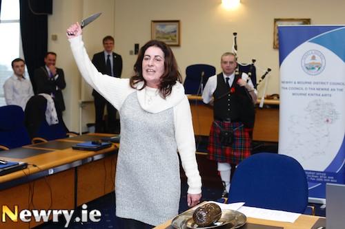 Ursuala Mhic an tSaoir, Irish Language Development Officer gets ready to stab the Haggis as the Burns Night celebrations get under way a day early in the Newry and Mourne Council Offices. Photograph: Columba O'Hare