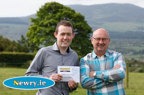 Camlough man, Ciaran O’Callaghan (left) pictured receiving his £300 feed mill cheque from William Hamilton of BGE (Northern Ireland).  Ciaran’s family won first prize in a draw for BGE (Northern Ireland) at the Dial Before You Dig stand at the Balmoral Show, Northern Ireland’s largest agricultural show. Photograph: Columba O'Hare