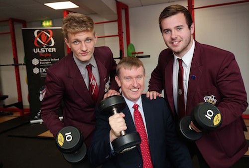 Minister for Social Development, Mervyn Storey MLA, is joined by pupils Kacper Janik (left) and Blaise McKnight as he tries out the equipment at the new sports facility at St Paul’s High School, Bessbrook. Photograph: Darren Kidd / Press Eye