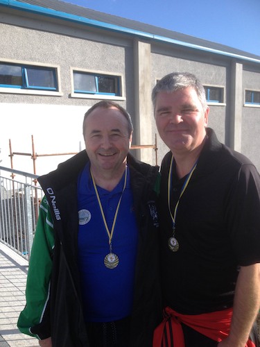 Cathal Boylan MLA & Pat Mc Ginn Camlough proudly show of their 10 mike Walk Medals at the Run for Autism.