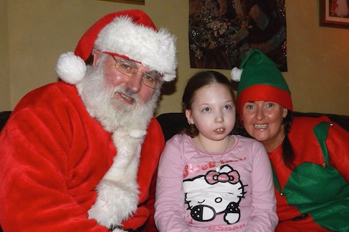 Santa and one of his helpers out on a visit.
