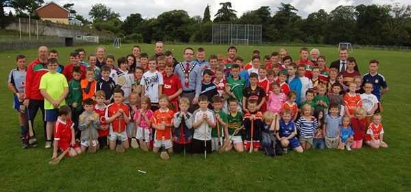 Newry & Mourne Mayor Dáire Hughes pictured with a group of those who attended this years Craobh Rua Camlocha Hurling Club Summer Camp