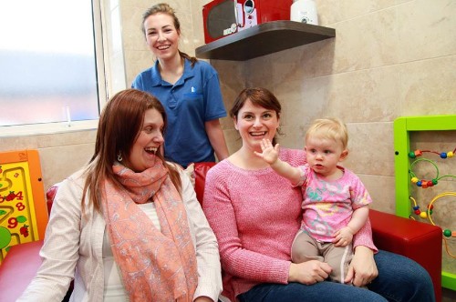 Adele Toal, Newry City Sure Start with winner of the survey competition Aileen Murphy, baby Emma and Deirbhile Craven  Buttercrane representative. 