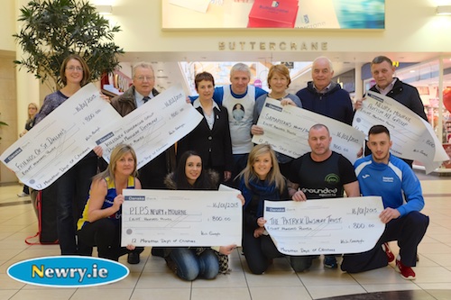 Kevin Gallagher ran twelve marathons in 12 days over the Christmas period on a treadmill in the Buttercrane Shopping Centre and raised £4,800 which was distributed equally to six local charities. Pictured along with Kevin are representatives of the local charities and as well as organisers and supporters. Back from left: Clare Shiels, Friends of St Dallan's; Brian McAnulty, Killowen Fundraising Group Duchenne Muscular Dystrophy; Therese Bailey, Buttercrane; Kevin; Eileen Winters and Liam Townson, Samaritans and Charlie Davis, Newry and Mourne Autism. Front Laura McGuigan, PIPS Newry and Mourne; Aisling Dinsmore, Patrick Dinsmore Trust,  Barry Duffy Slieve Gullion Runners and Declan KMS Sports. Photograph: Columba O'Hare 