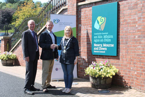 The new Chairperson of Newry, Mourne and Down District Policing and Community Safety Partnership, Councillor Mickey Larkin is congratulated by Newry, Mourne and Down District Council Chair, Councillor Naomi Bailie and Council Chief Executive, Mr Liam Hannaway. The new Chairperson of Newry, Mourne and Down District Policing and Community Safety Partnership, Councillor Mickey Larkin is congratulated by Newry, Mourne and Down District Council Chair, Councillor Naomi Bailie and Council Chief Executive, Mr Liam Hannaway.