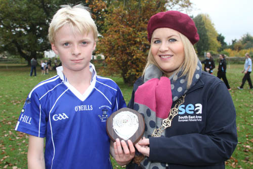 Winner of the Boys Minnows 1k Race Calum St Colman's College accepts his award from Chairperson Newry, Mourne and Down Council Naomi Bailie. Winner of the Boys Minnows 1k Race Calum St Colman's College accepts his award from Chairperson Newry, Mourne and Down Council Naomi Bailie.