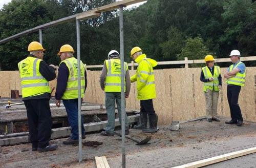 Branch members standing on the normally vertical part of the gates.