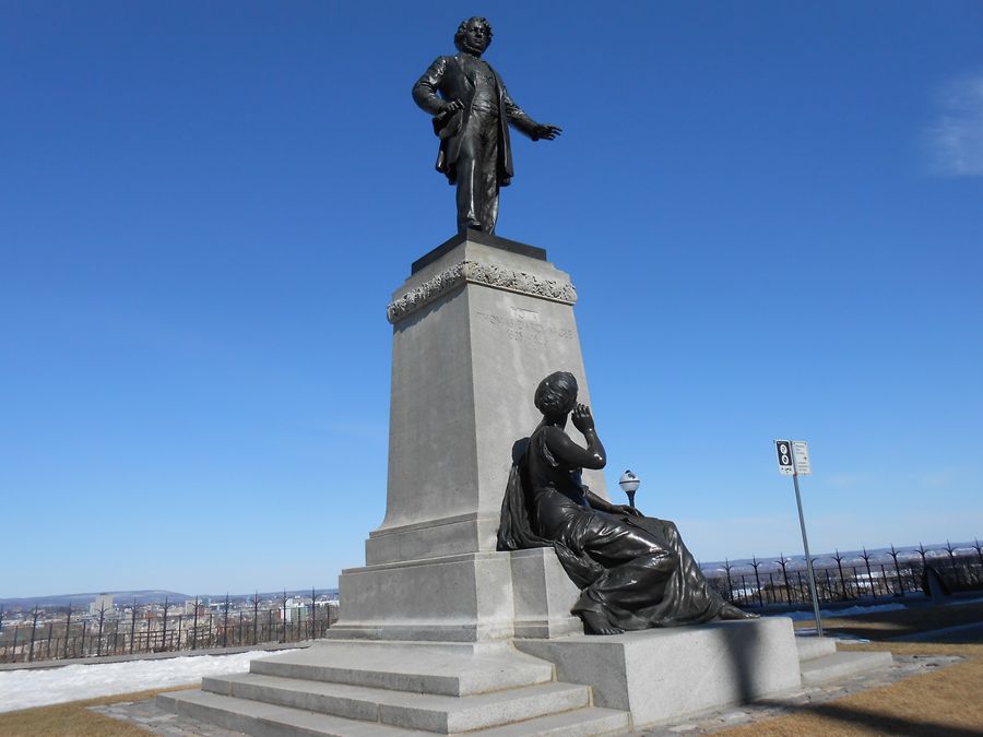  A statue of Thomas D'Arcy McGee that stands at the Ottawa Parliament Building in Canada with the young nation listening  to his wisdom.