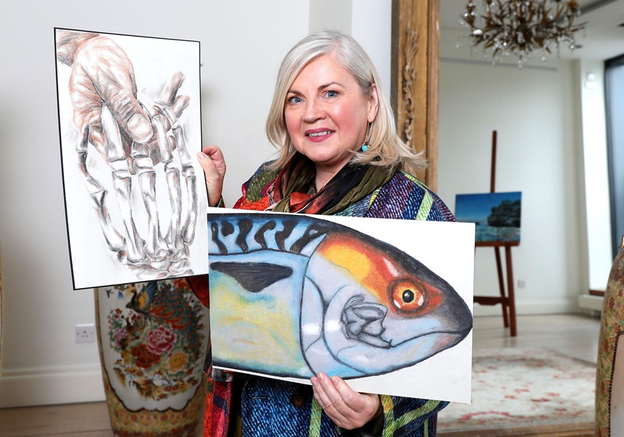 Adjudicator Noelle McAlinden admiring two of the entries received from Co. Down this year – one entitled ‘Death’s Touch’ (left) and another entitled ‘The Mackerel’, both by pupils at Abbey Grammar School in Newry.